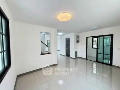 Spacious modern living room with sleek tile flooring and large windows