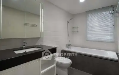 Modern bathroom with sleek design, featuring a bathtub and elegant fixtures.