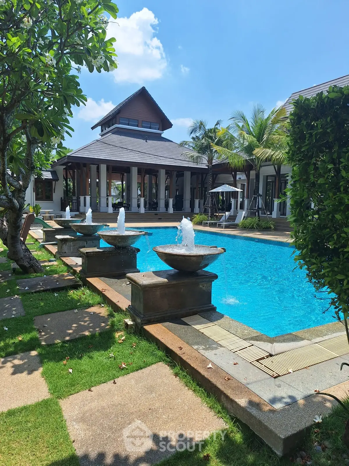 Luxurious villa with stunning pool and lush garden, perfect for relaxation and entertaining.