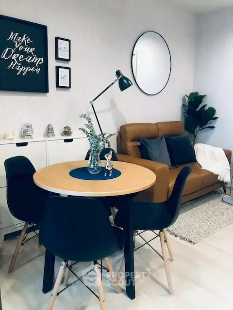 Chic living room with modern decor, featuring a cozy sofa, stylish dining set, and elegant wall art.