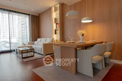 Elegant modern living room with dining area and large windows in a high-rise apartment.