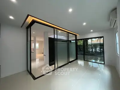 Modern living room with glass partition and natural light