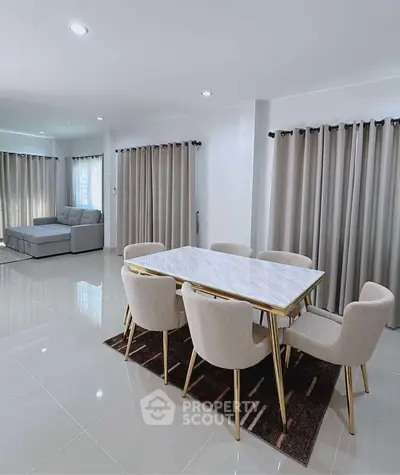 Modern dining area with elegant marble table and plush chairs in open living space
