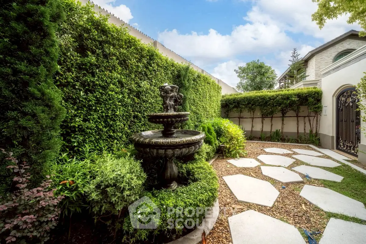 Charming garden with lush greenery and elegant stone fountain, perfect for serene outdoor living.