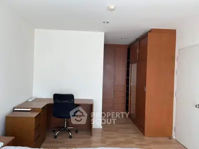 Spacious bedroom with built-in wardrobe and study desk, perfect for modern living.