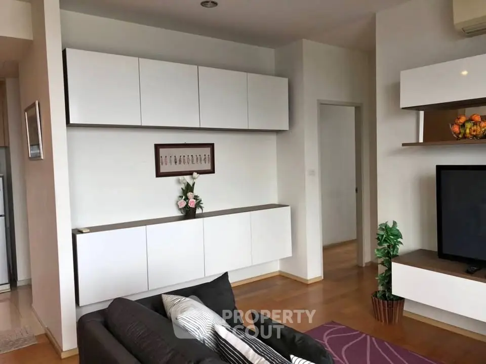 Modern living room with sleek white cabinets and cozy seating area