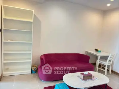 Chic living room with vibrant pink sofa and modern decor