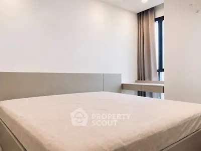 Modern minimalist bedroom with large bed and natural light