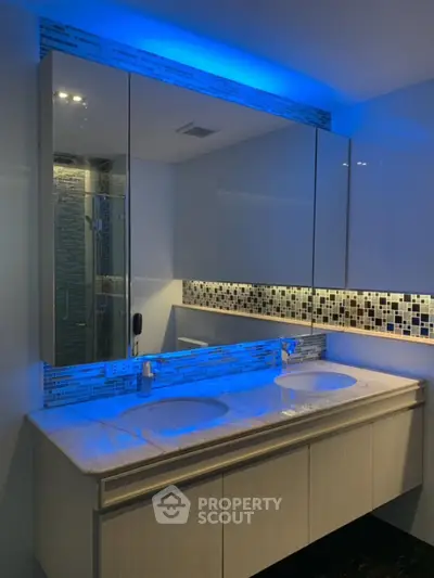 Luxurious modern bathroom with dual sinks and ambient lighting