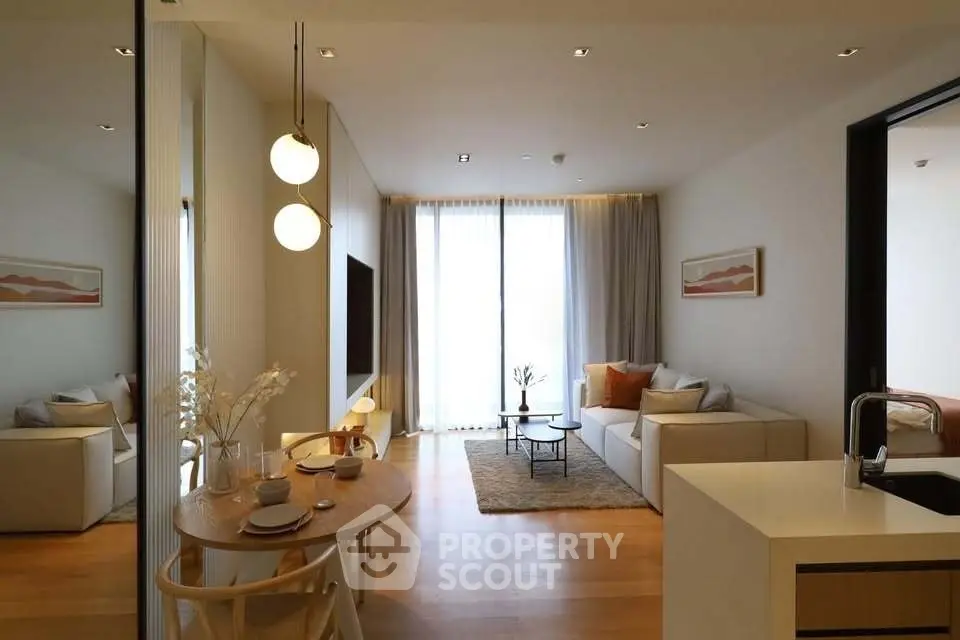 Modern living room with elegant decor and open layout, featuring cozy seating and stylish lighting.
