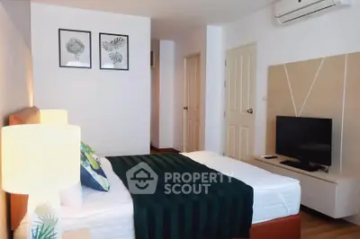 Modern bedroom with stylish decor and air conditioning in a cozy apartment.