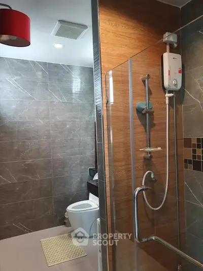 Modern bathroom with sleek shower and stylish tiles in contemporary apartment