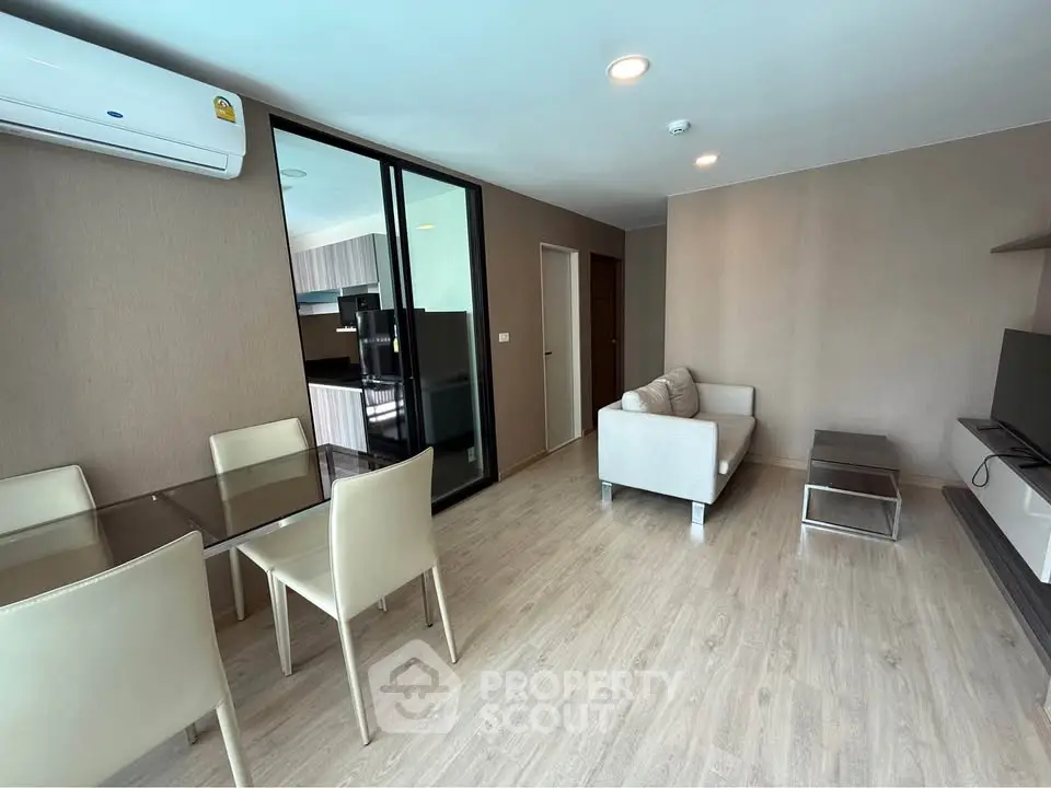 Modern living room with dining area and open kitchen in stylish apartment