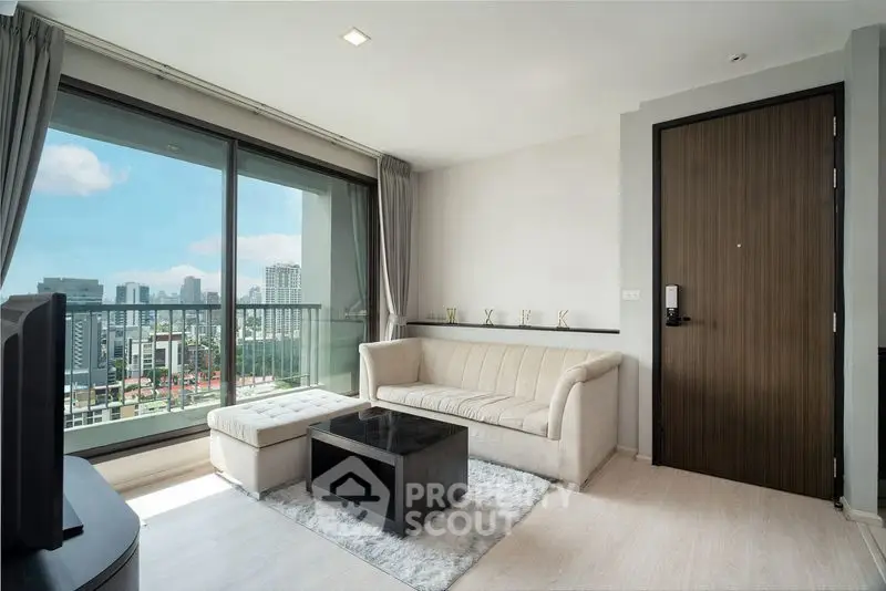 Modern living room with city view and stylish furniture in high-rise apartment.