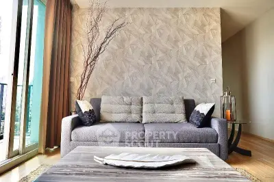 Modern living room with stylish decor and large windows offering natural light.