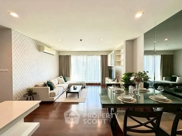 Spacious modern living room with elegant dining area and large windows for natural light.