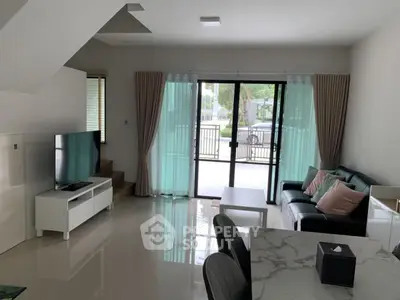 Modern living room with sleek furniture and large windows for natural light