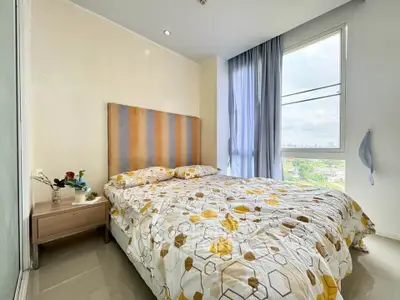 Bright bedroom with modern decor and large window view