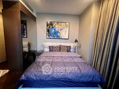 Luxurious bedroom with modern decor and elegant bedding in a stylish apartment.