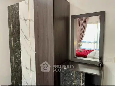 Stylish bedroom with modern wardrobe and vanity mirror