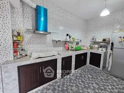 Modern kitchen with mosaic tiles and stainless steel appliances