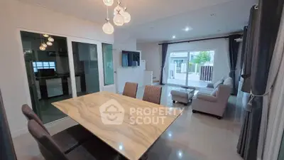 Spacious modern living room with elegant marble dining table and cozy seating area.