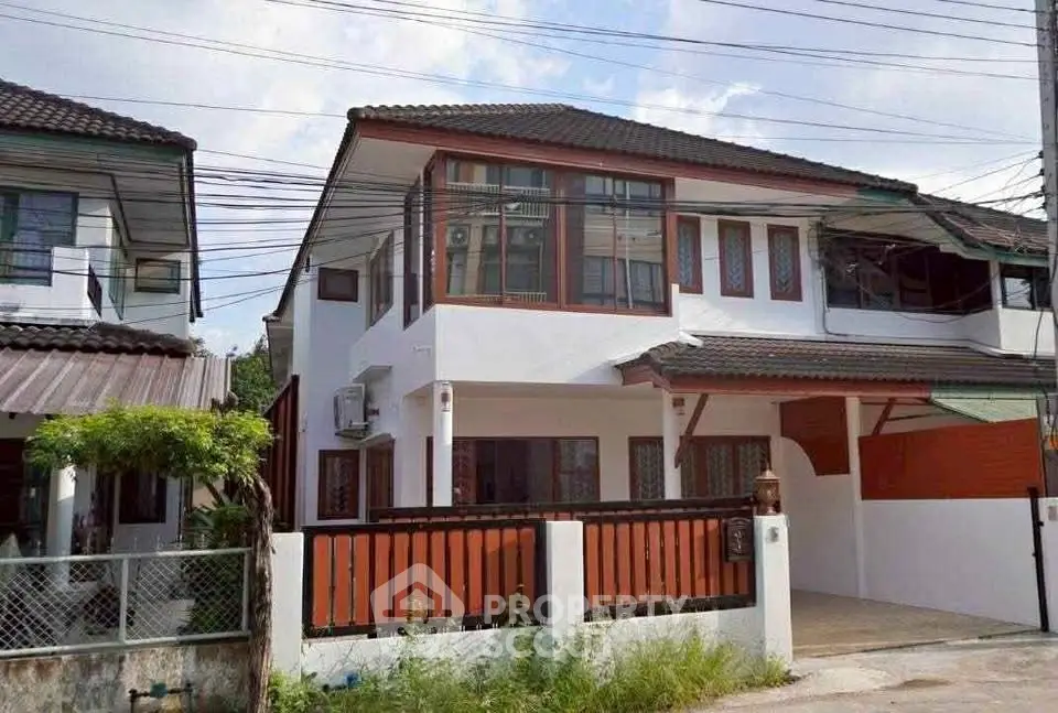 Charming two-story house with modern design and spacious driveway in a serene neighborhood.