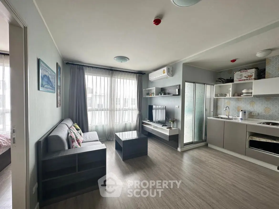 Modern living room with open kitchen and stylish decor in a bright apartment.