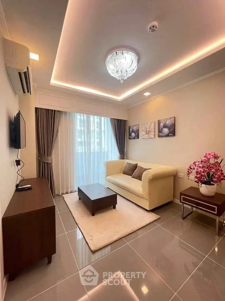 Elegant living room with modern decor, featuring a plush sofa, stylish lighting, and large window for natural light.