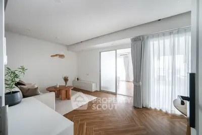 Spacious modern living room with elegant wooden flooring and natural light