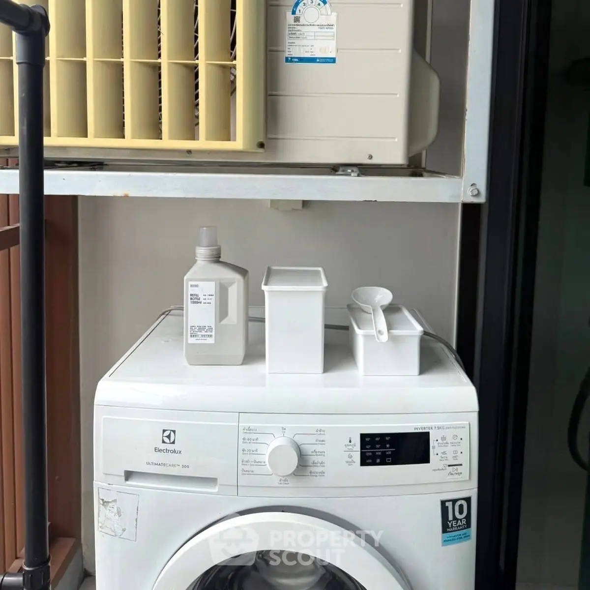 Modern washing machine on balcony with air conditioning unit above, perfect for urban living convenience.