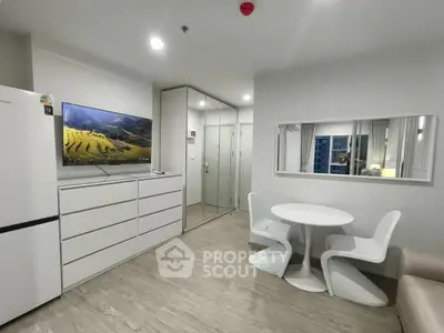 Modern living room with sleek furniture and wall-mounted TV in a stylish apartment.