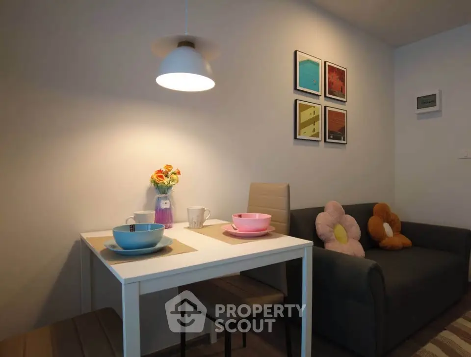 Cozy dining area with modern decor and stylish lighting in a compact living space.