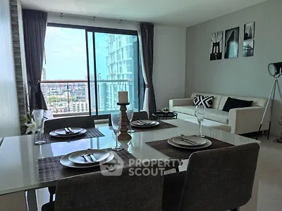 Modern dining and living area with city view from large windows