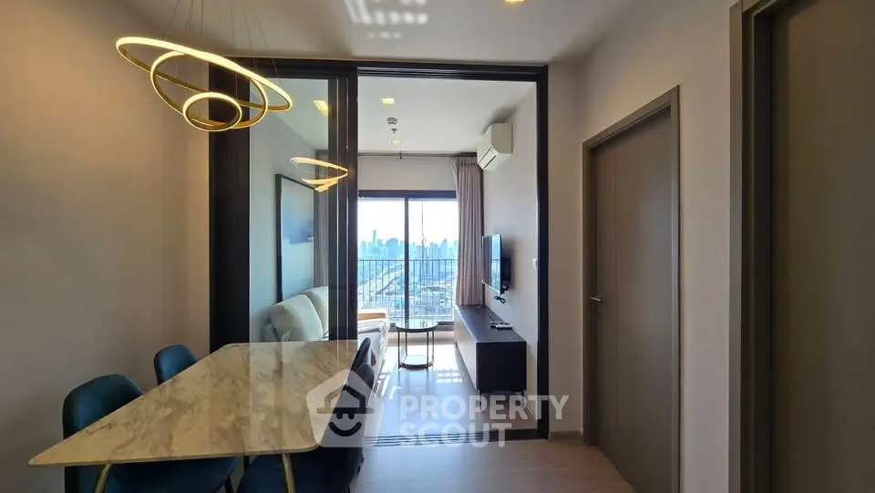 Modern living room with city view, stylish lighting, and elegant dining area in a high-rise apartment.