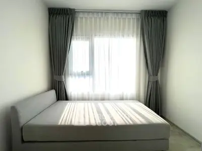 Minimalist bedroom with natural light and elegant curtains