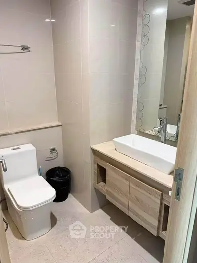 Modern bathroom with sleek fixtures and elegant vanity in a contemporary home.