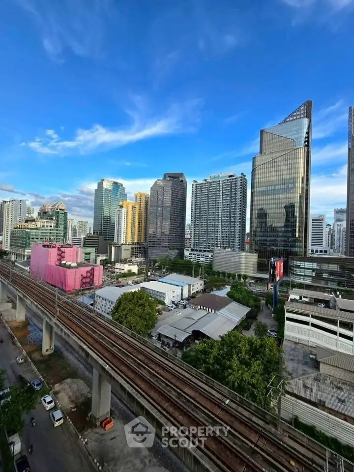 Stunning cityscape view with modern skyscrapers and railway, perfect for urban living enthusiasts.