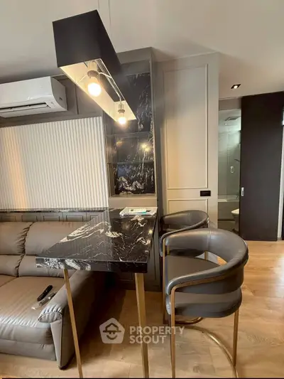 Modern living room with sleek marble table and stylish lighting