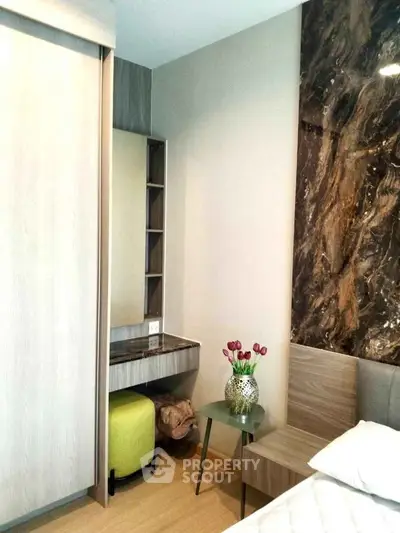Modern bedroom with stylish decor and elegant marble accent wall
