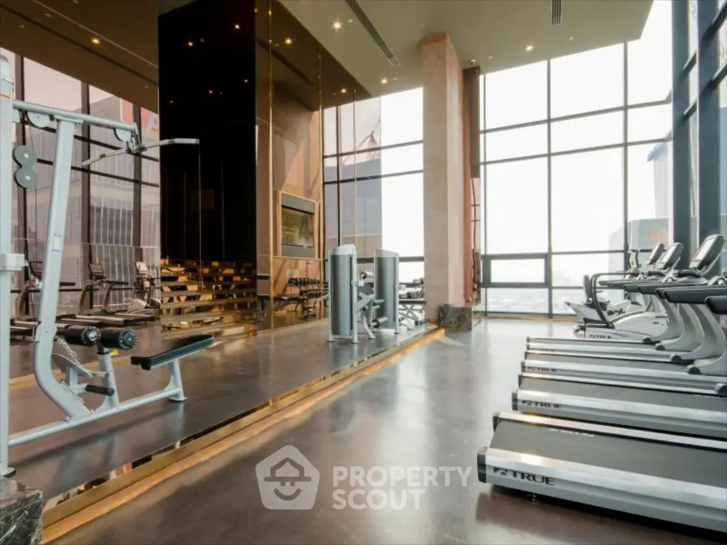 Luxurious high-rise gym with modern equipment and panoramic city views.