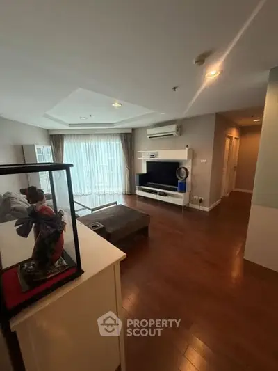 Spacious living room with hardwood floors and modern decor