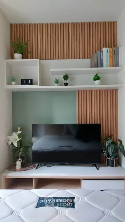 Modern living room with stylish TV setup and decorative shelving