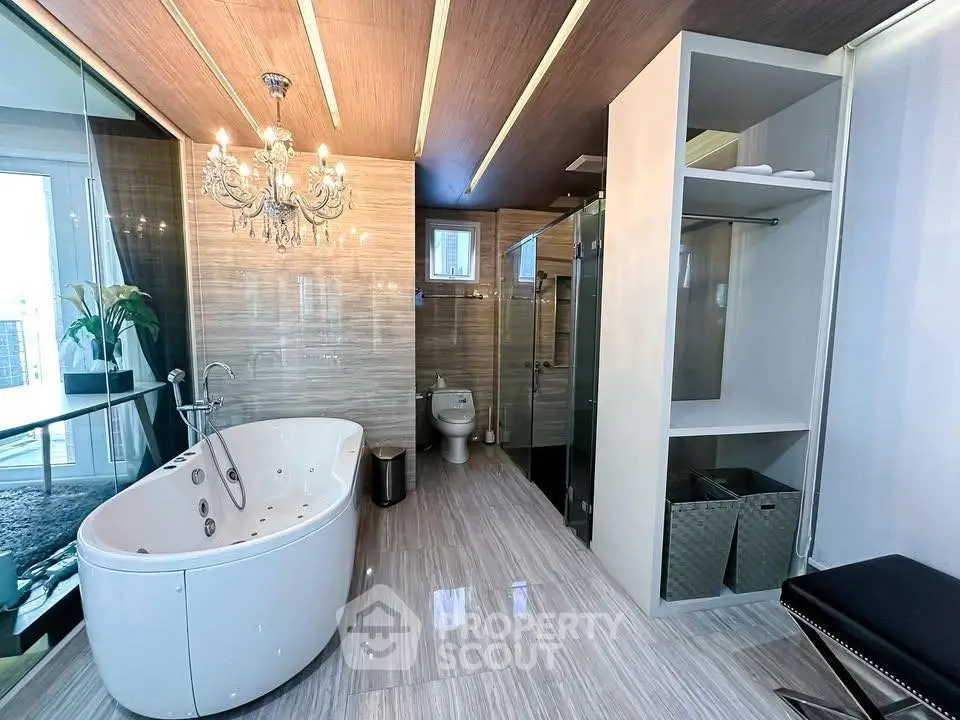 Luxurious bathroom with elegant chandelier and modern bathtub