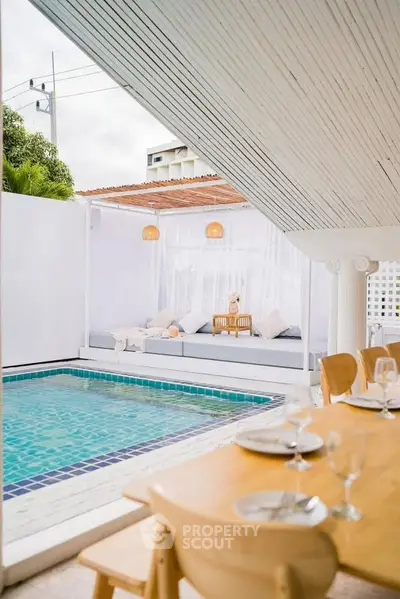 Luxurious poolside dining area with elegant seating and serene ambiance