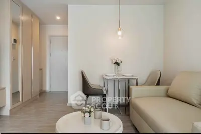 Modern living room with elegant decor and cozy seating area in a stylish apartment.