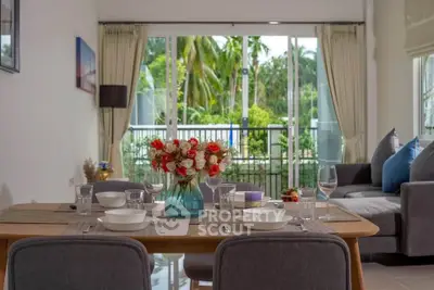 Elegant dining area with garden view, featuring a stylish table setting and cozy seating.