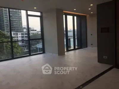 Spacious modern living room with large windows and city view