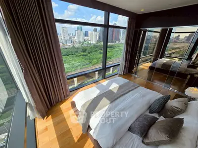 Luxurious bedroom with stunning city view and floor-to-ceiling windows