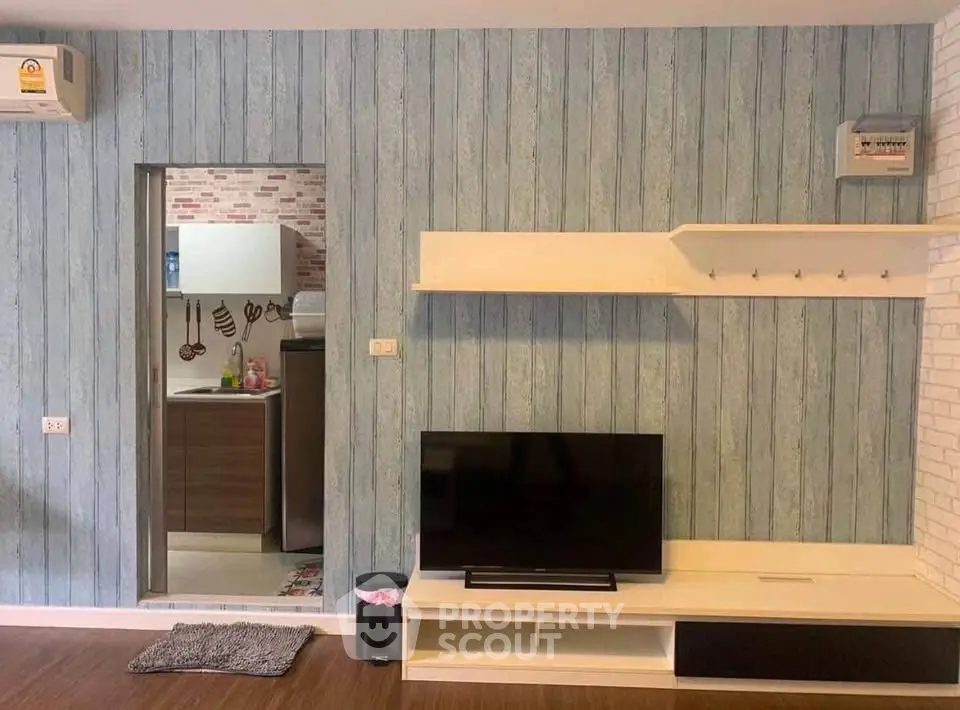 Modern living room with stylish TV unit and kitchen view